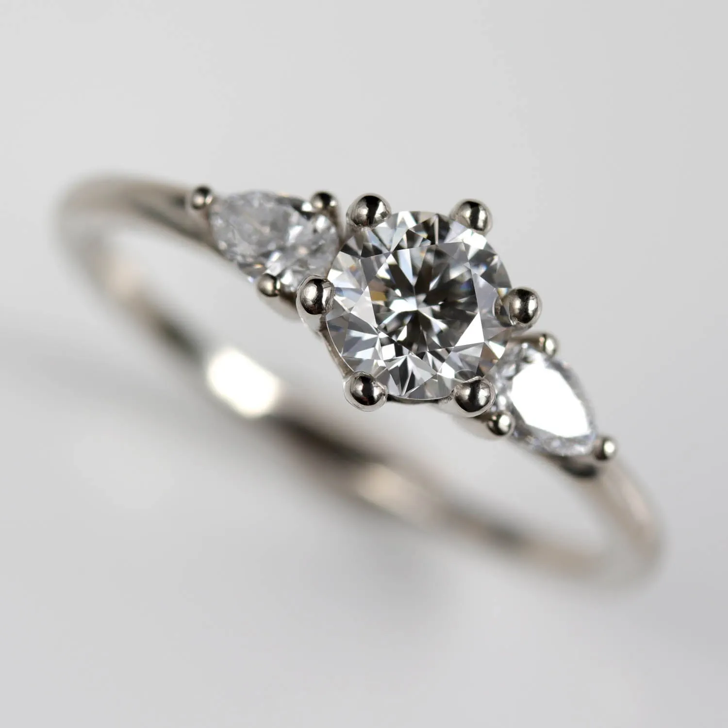 5mm Prong-set Three Stone Ring with Pear-Shaped Side Stones