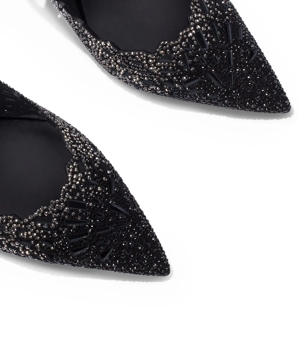 Black suede pumps with crystal embellishments and laser-cut details.